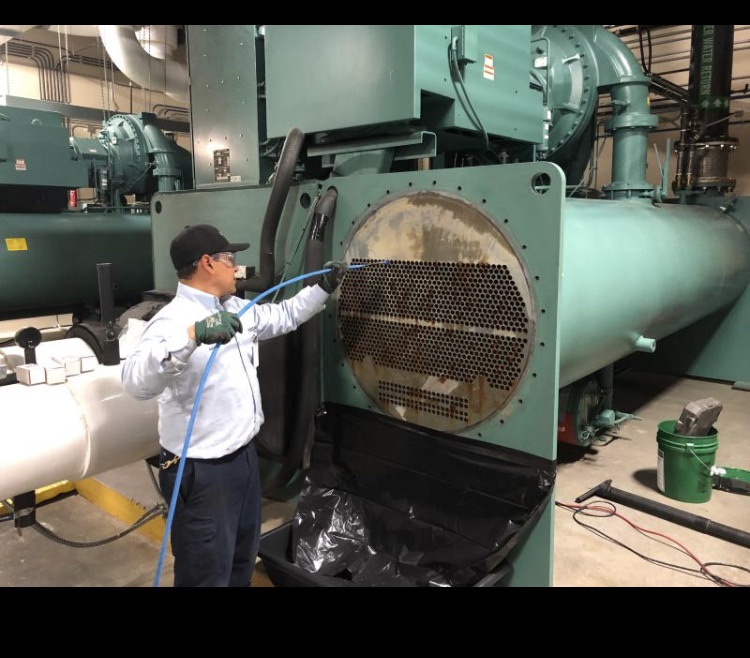 Technician servicing a chiller condenser bundle